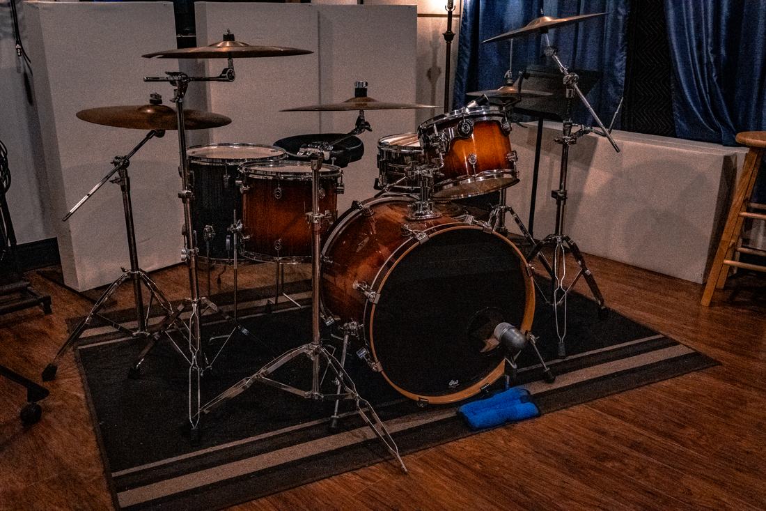 Drum kit with blue curtain backdrop
